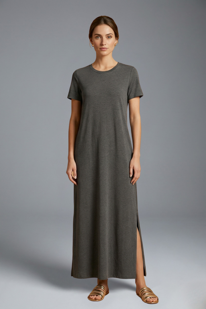 Woman wearing flowy maxi dress front view gray background