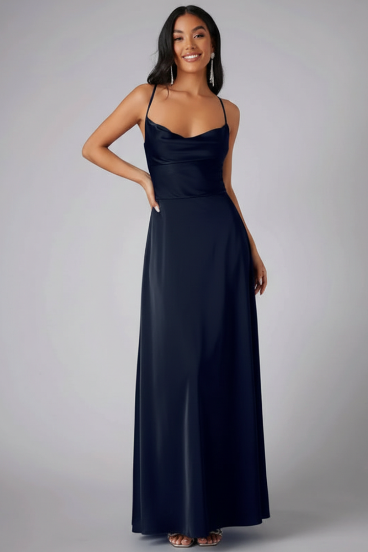 Woman wearing bodice dress with flowing skirt on gray background