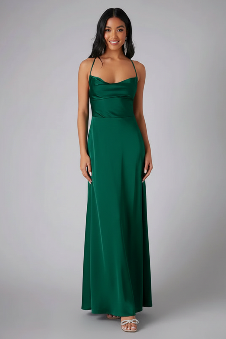 Female model standing in sleeveless evening dress on gray background
