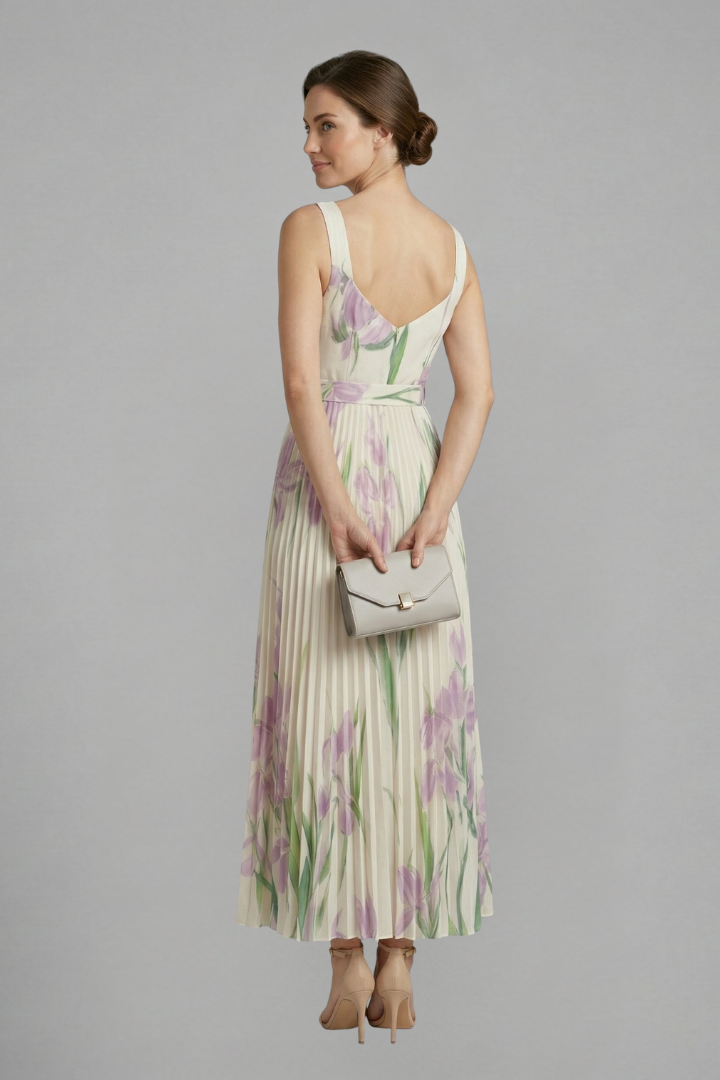 Back view model with clutch wearing heels and long floral dress gray background