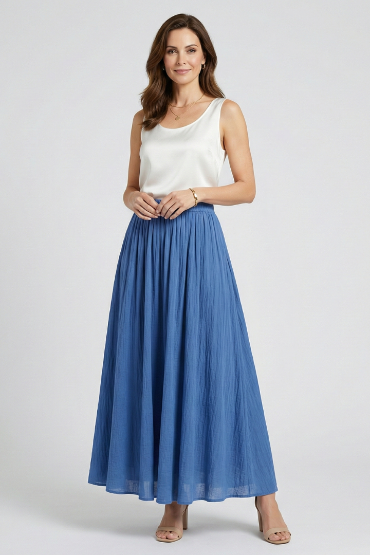Model front view in flared blue maxi skirt gray-background