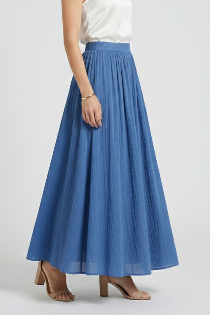 Model standing sideway wearing elastic waist skirt in gray-background