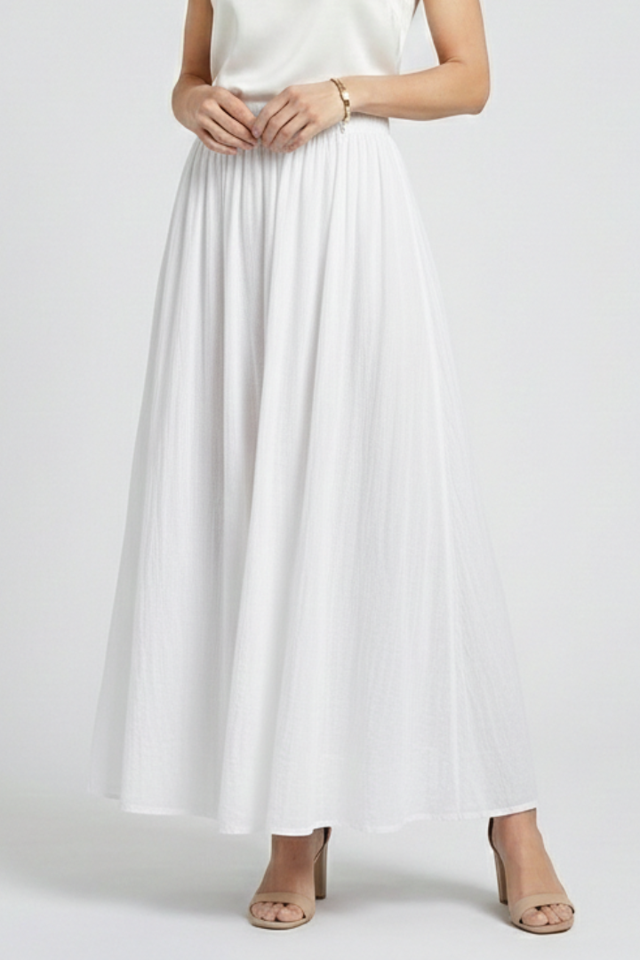 Woman in front angle in floor-length white skirt and in white top