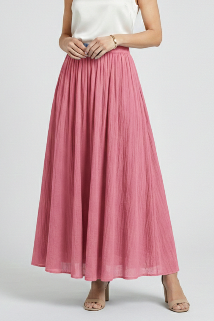 Model angled front pose in flared pink skirt in gray-background