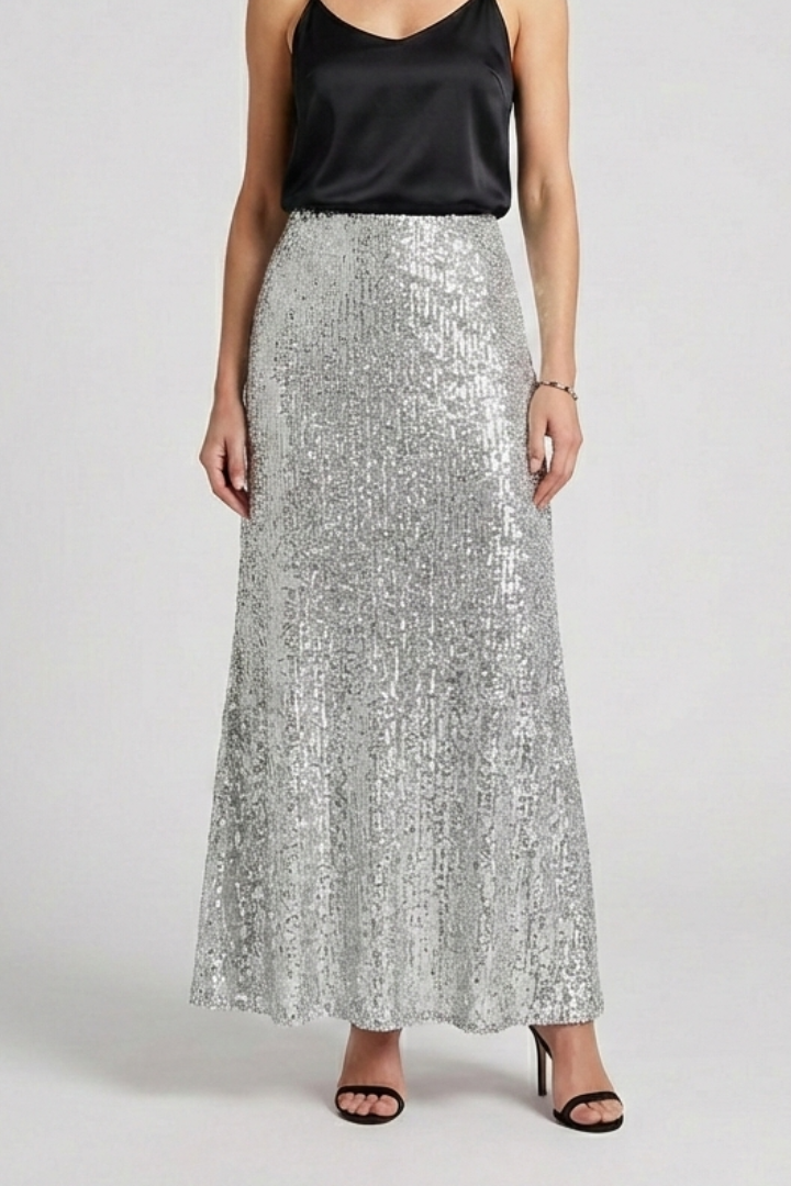 Model in high waist shimmer skirt gray background
