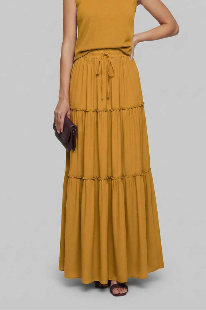 Studio shot model in flowy maxi yellow skirt