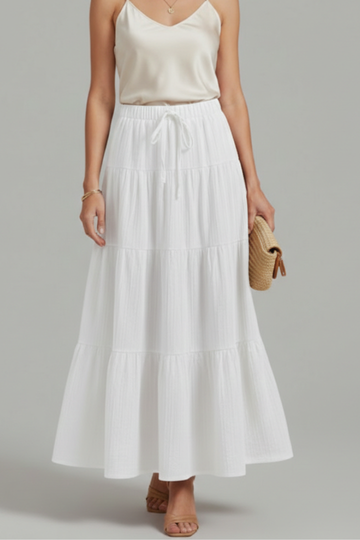 Casual fashion model in layered long white skirt and white top