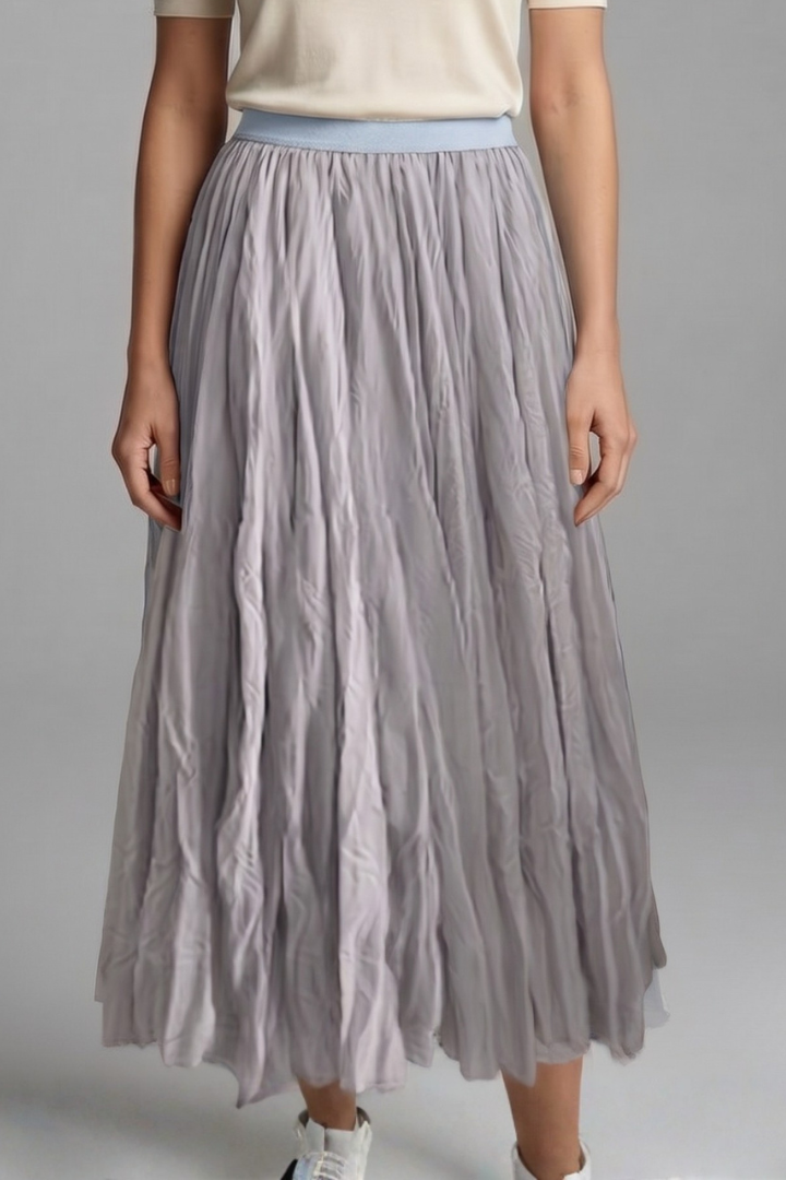 Model wearing a wide drape pleated skirt with pull-on design on a plain background.