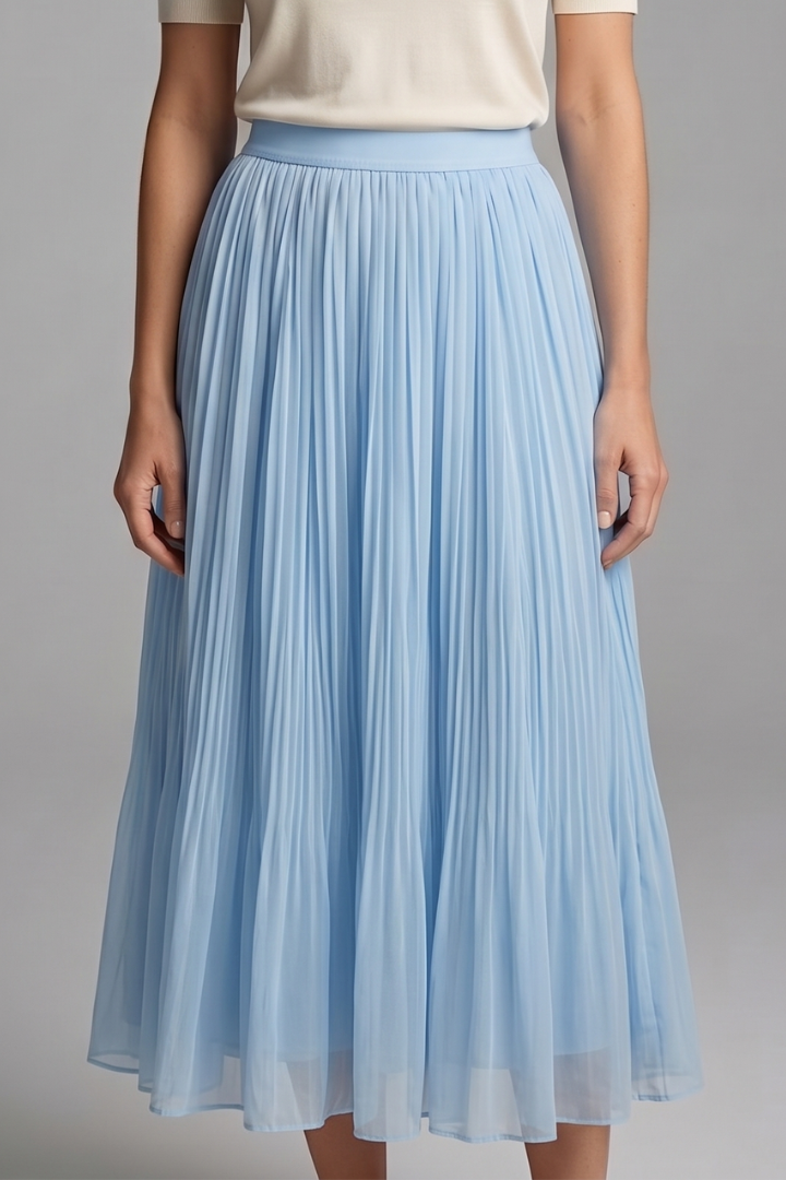 Model in a long pull-on skirt with vertical pleat detailing on a plain background.