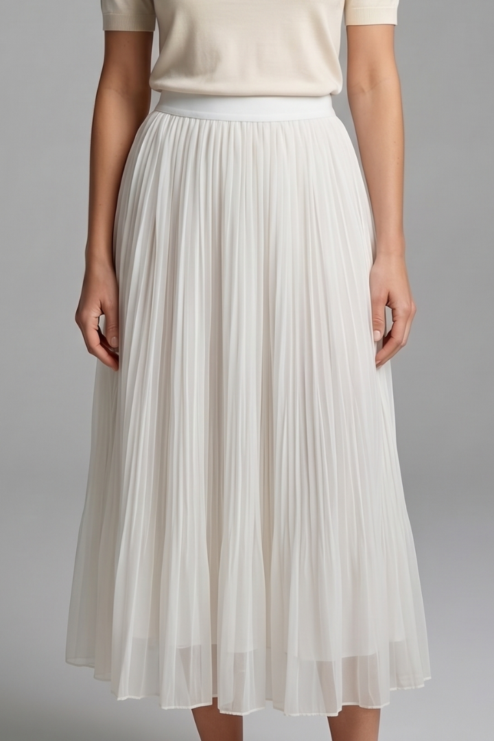 Woman showing a pleated floor-length skirt with stretch waistband on a plain background.