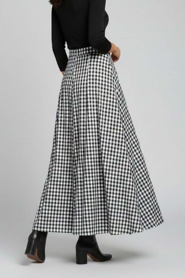 Full body model wearing long skirt gray background in back angle view