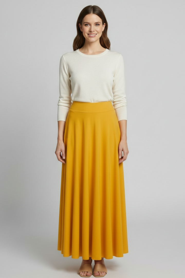 Model wearing long A-line skirt on gray background