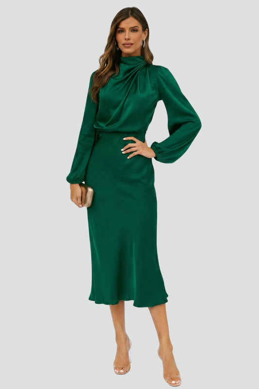 Female model wearing midi green dress front view on plain gray background