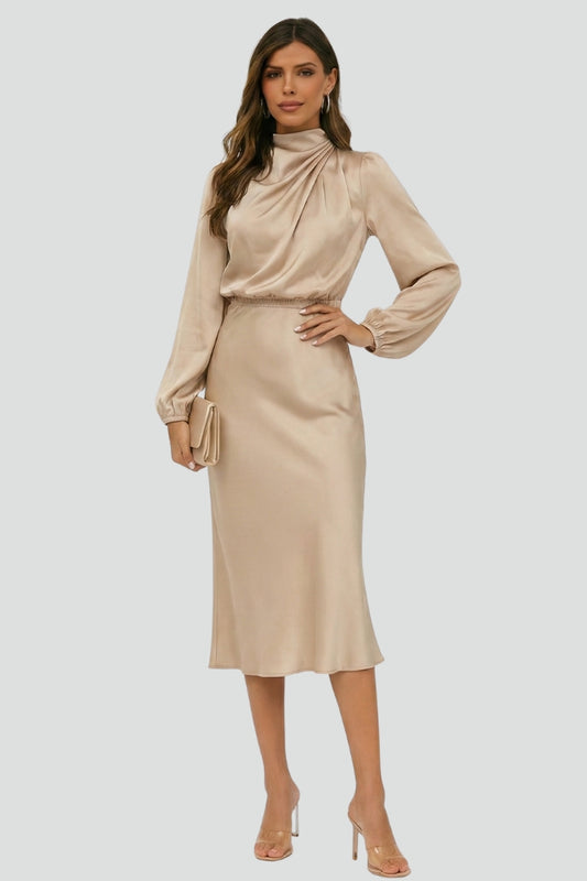 Woman in long sleeve woven dress three quarter angle gray background.