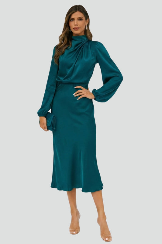 Female model showing full length dress silhouette gray background.