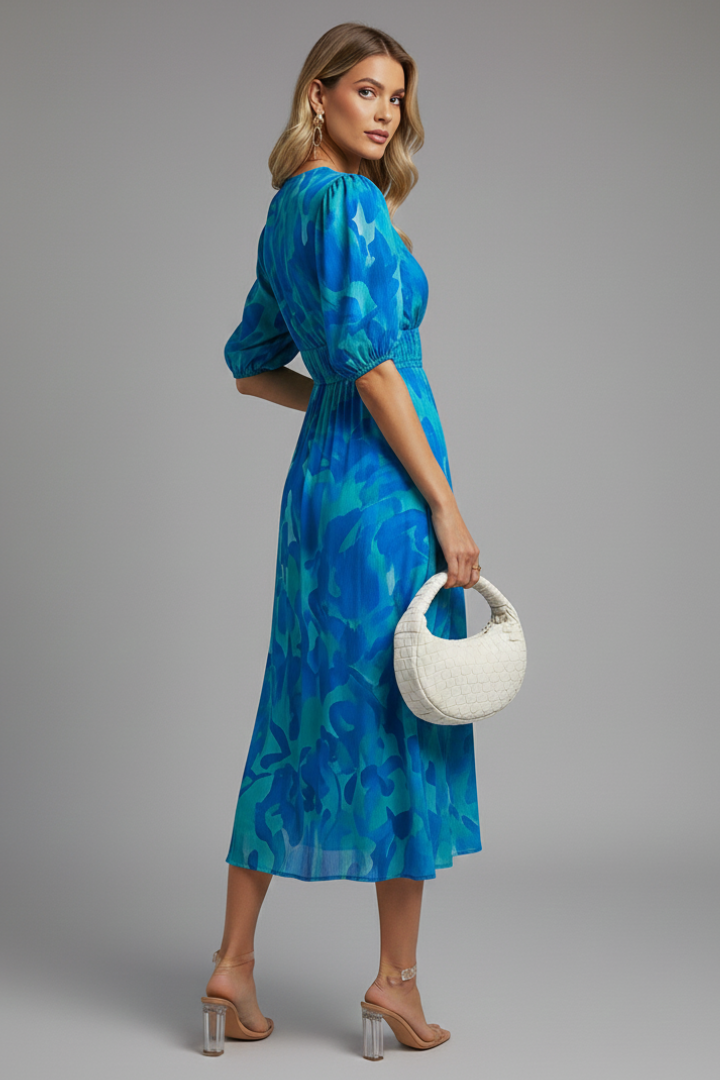 Female model displaying side detail of floral midi dress.