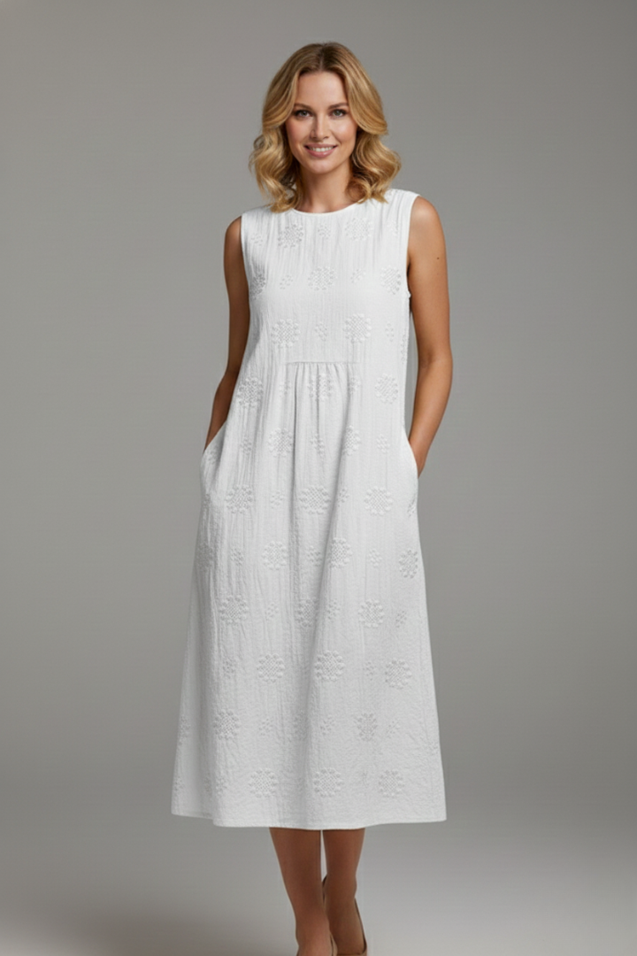 Female model showing full-length textured dress with relaxed silhouette elegantly.