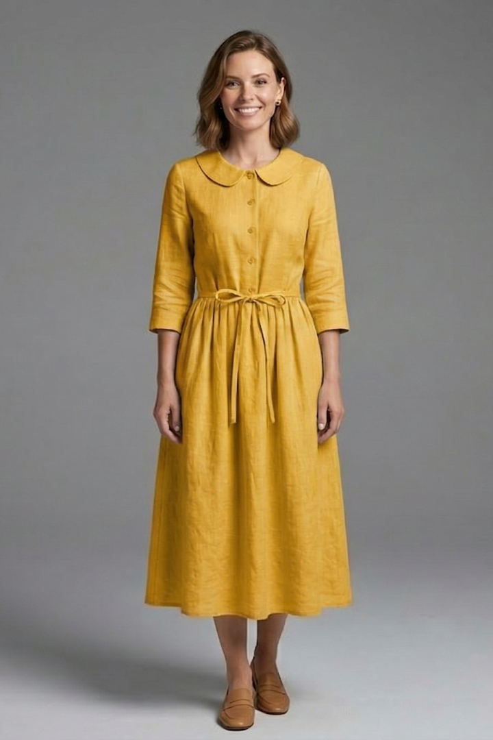 Woman wearing soft drape dress front angle gray background.