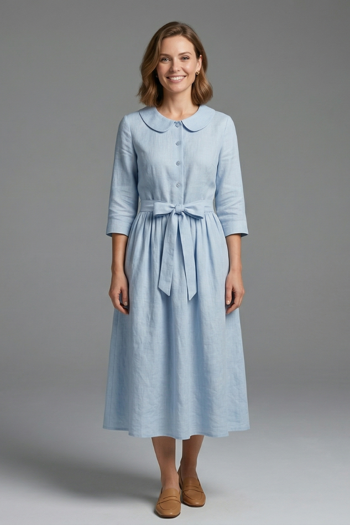 Woman wearing midi dress front view on plain gray background.