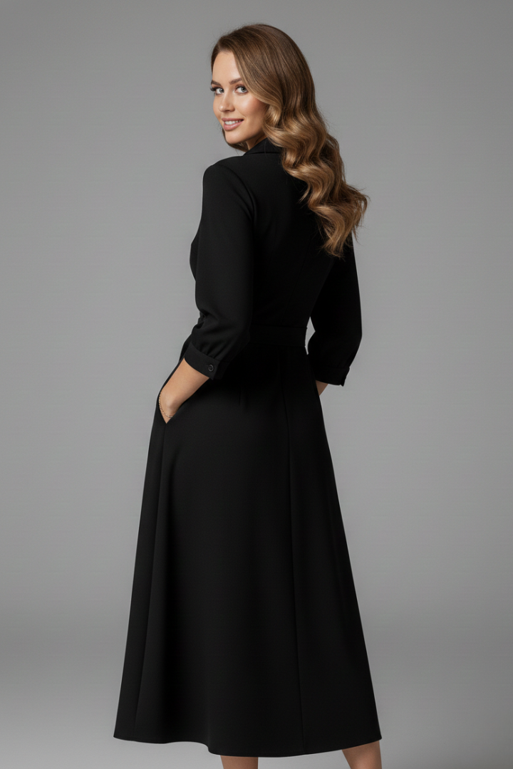 Woman showing side/back angle of midi dress on gray background.
