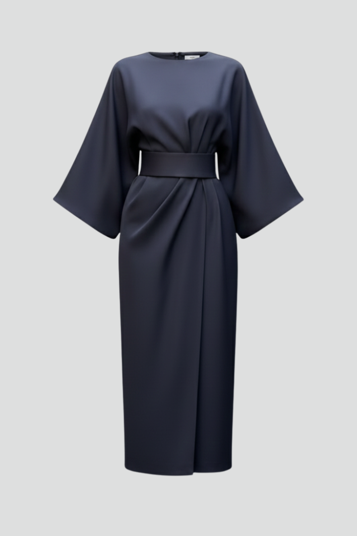 Flowing midi dress against plain gray background.