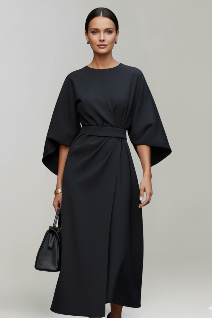 Woman in casual elegant midi dress, side angle, gray background.