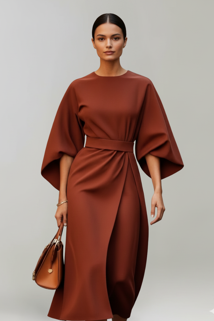 Female model showing dress silhouette from back angle, gray background.