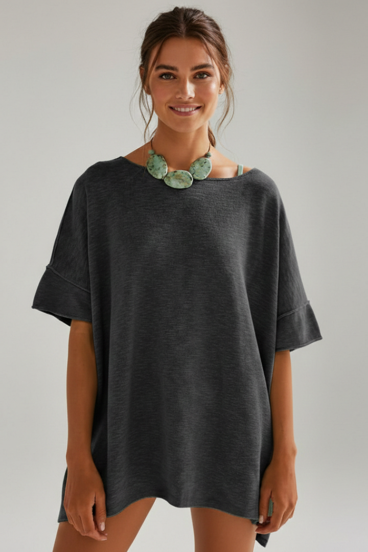 Clean product image of roomy model smiling wearing fashion top tee