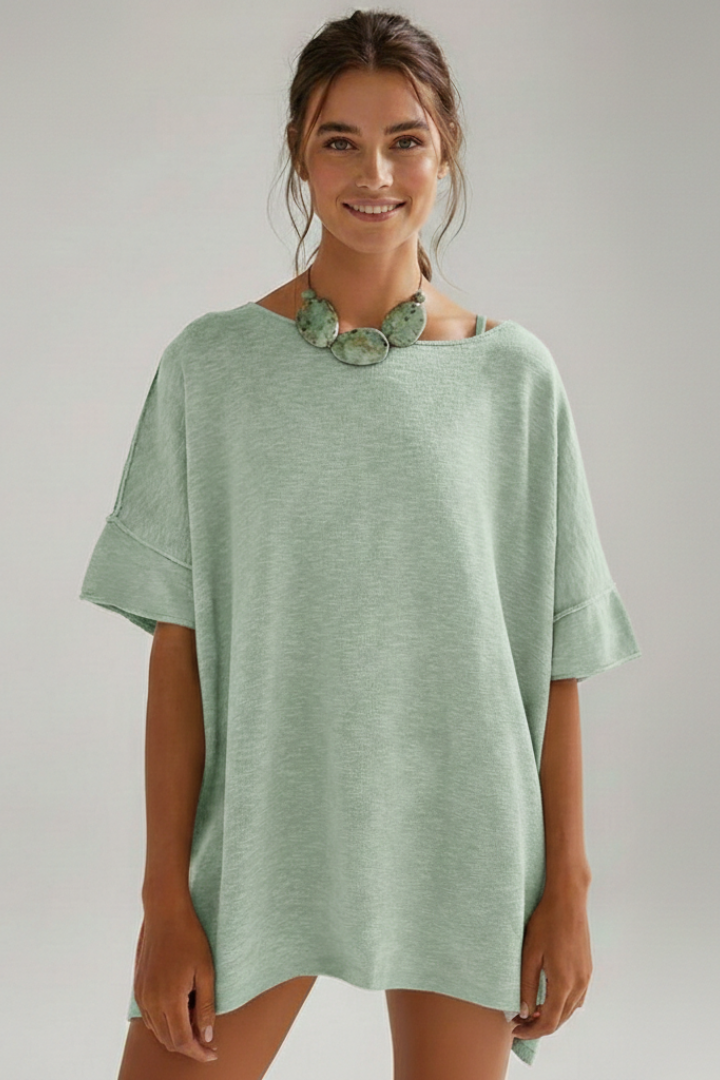 Model front view smiling wearing fashion tee piece with roomy fit front display