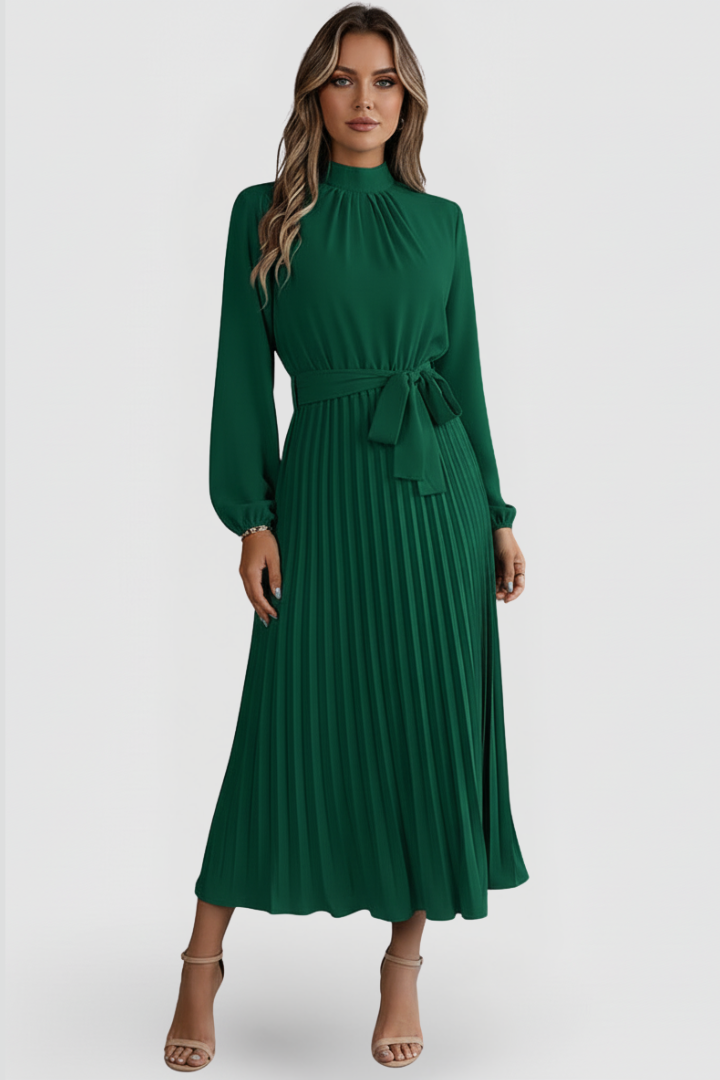 Woman posing front view in modest pleated green dress