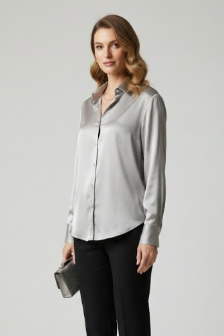 Side view glossy silver blouse on model plain studio backdrop