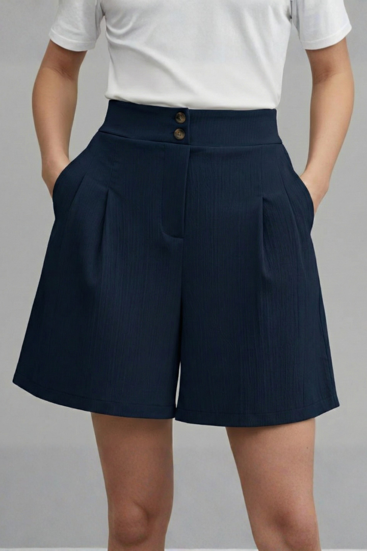 Pleated front navy shorts displayed on female model