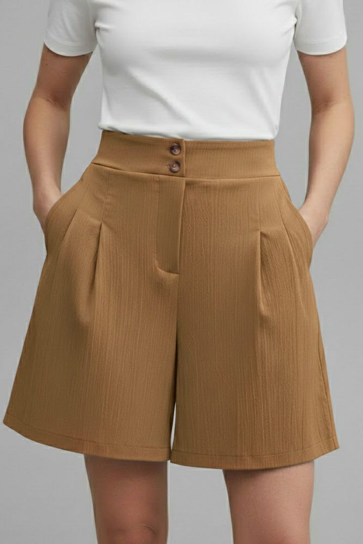 Female model standing wearing brown side pocket short, front angle on gray background
