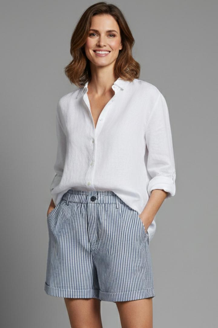 Woman wearing striped shorts front view and in gray background