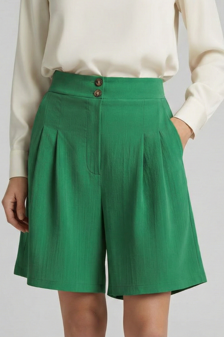 Female model fashion pose in green shorts summer style