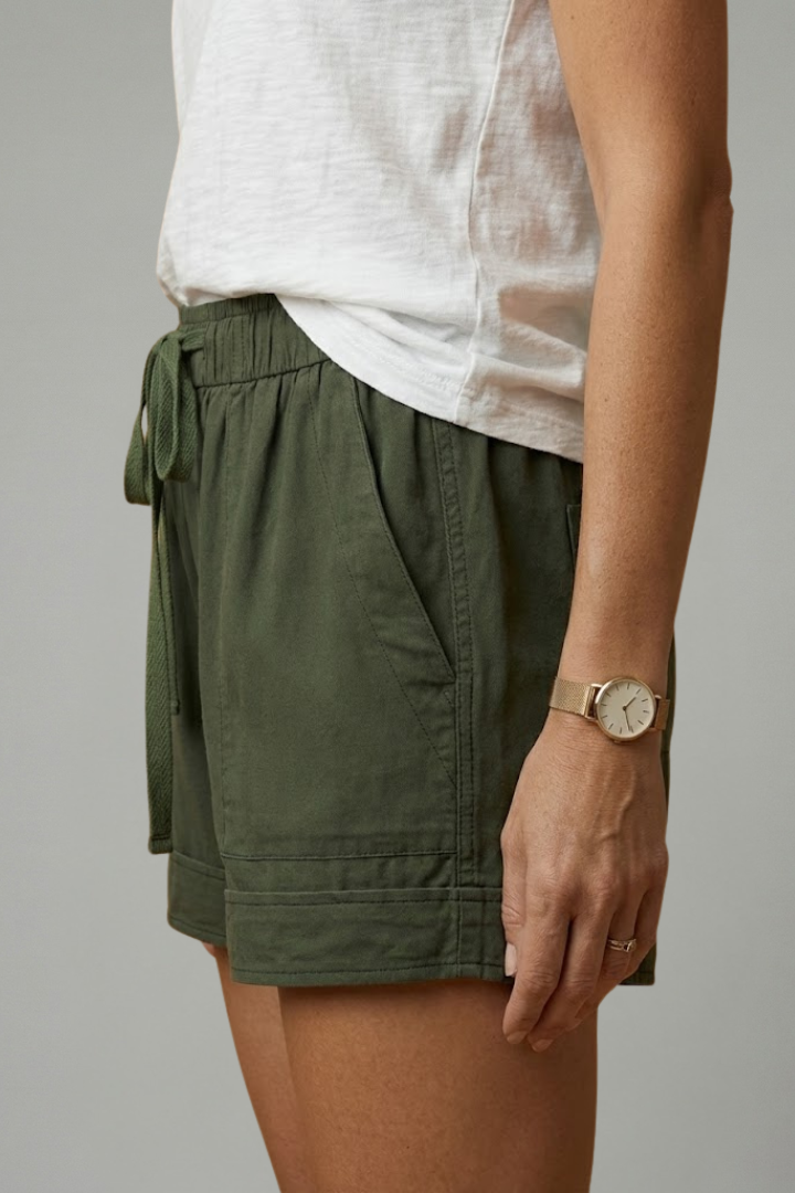 Female model relaxed pose with pocket shorts side view