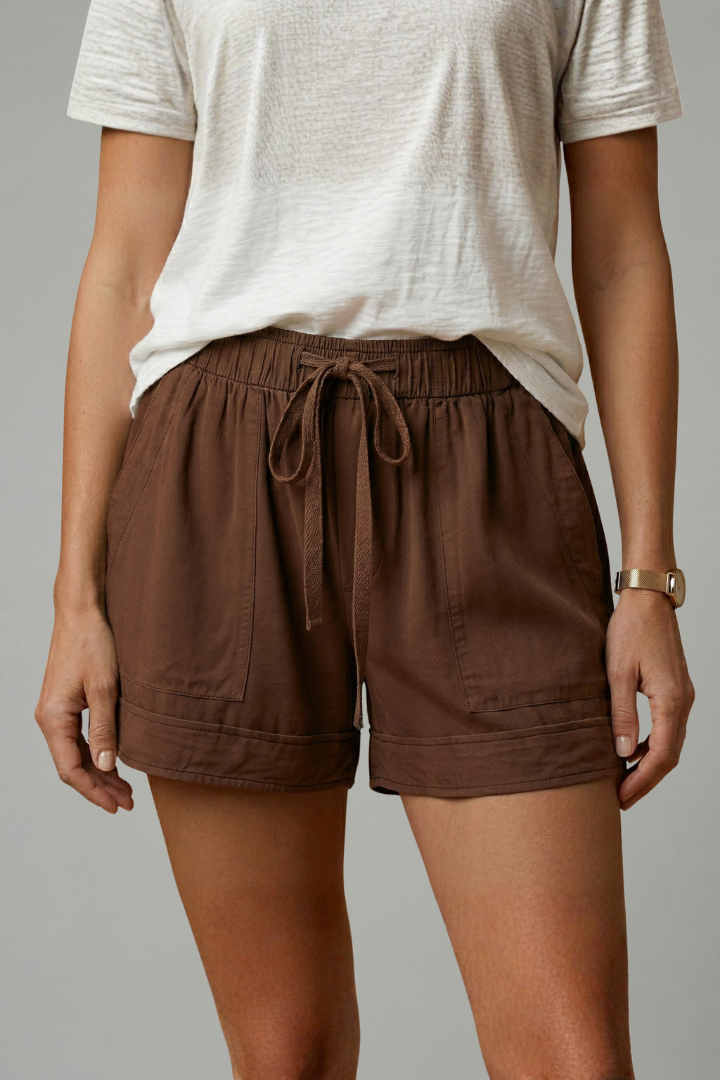Model wearing comfortable drawstring shorts on gray backdrop