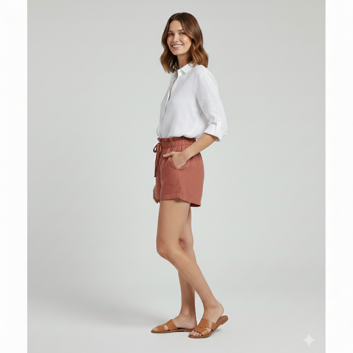 Full body view of model wearing drawstring shorts and white top
