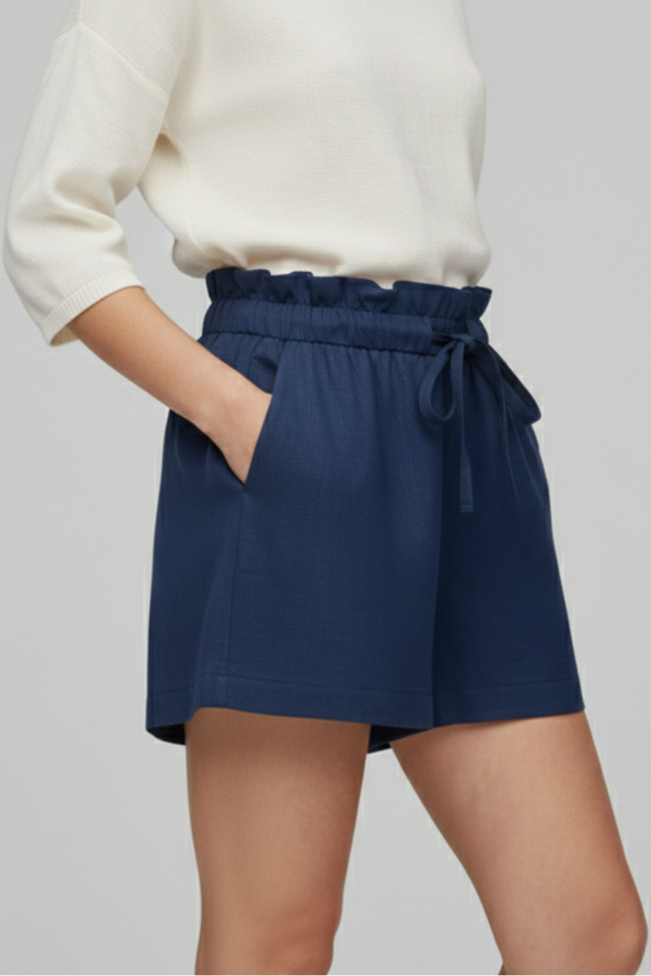 Women side posing in casual shorts gray background