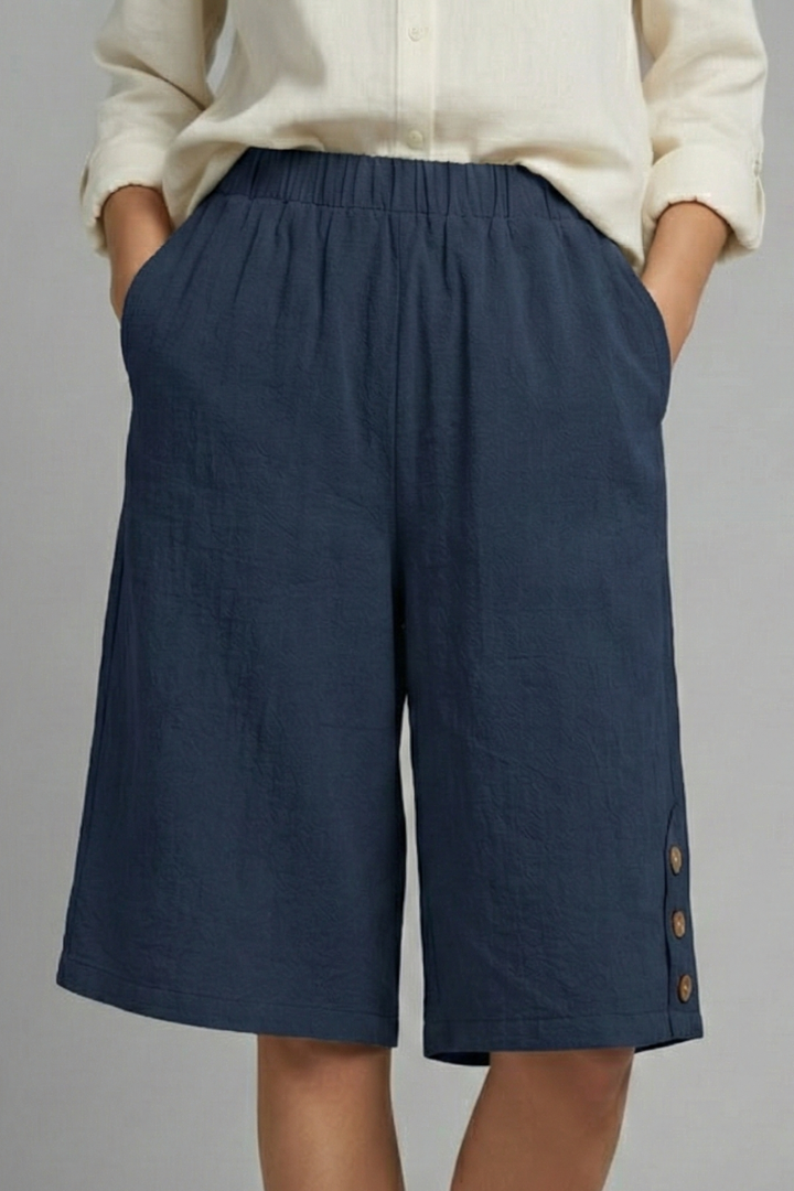 Side button shorts with pockets on female model standing