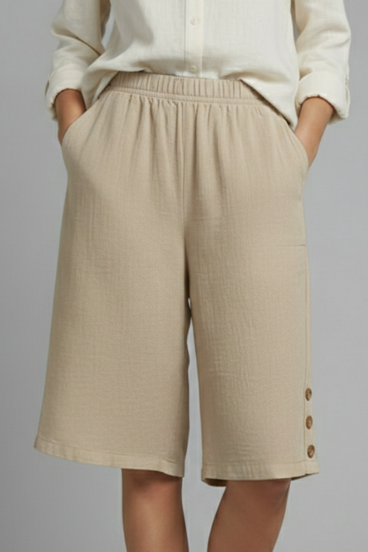Elastic waistband shorts on model gray backdrop