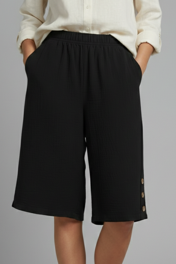 Black loose fit shorts with pockets on model gray background