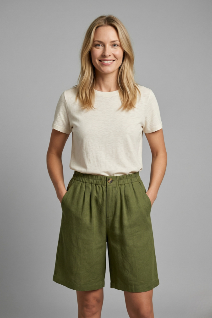 Female model wearing loose shorts, front view, gray background