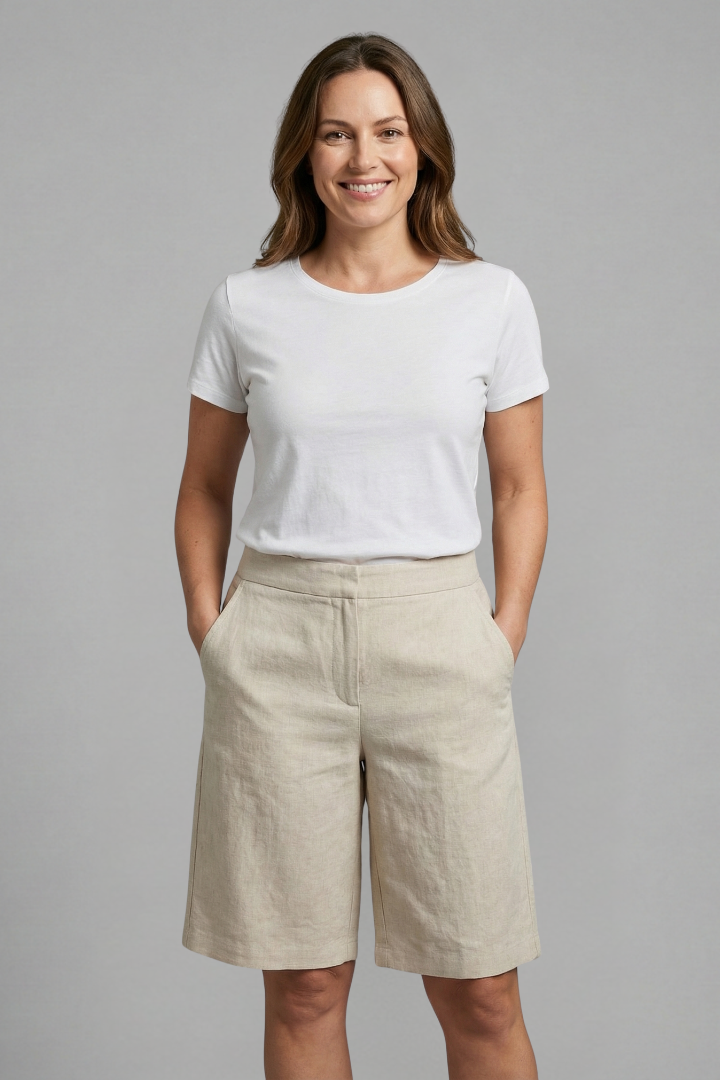 Model wearing knee-length shorts on plain gray background