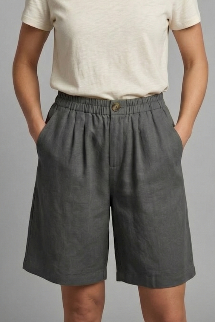 Relaxed fit shorts on model, plain gray background