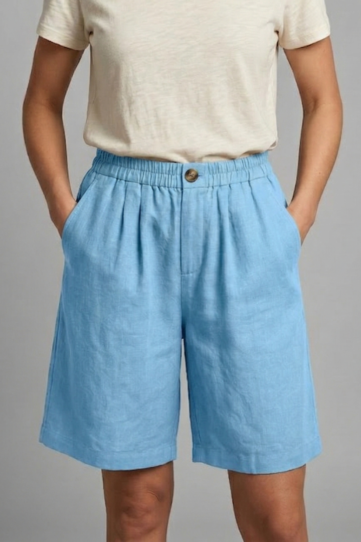 Waistband shorts on female model, gray background