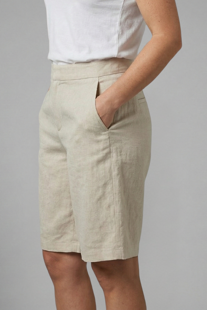 Model posing in textured shorts plain gray setting