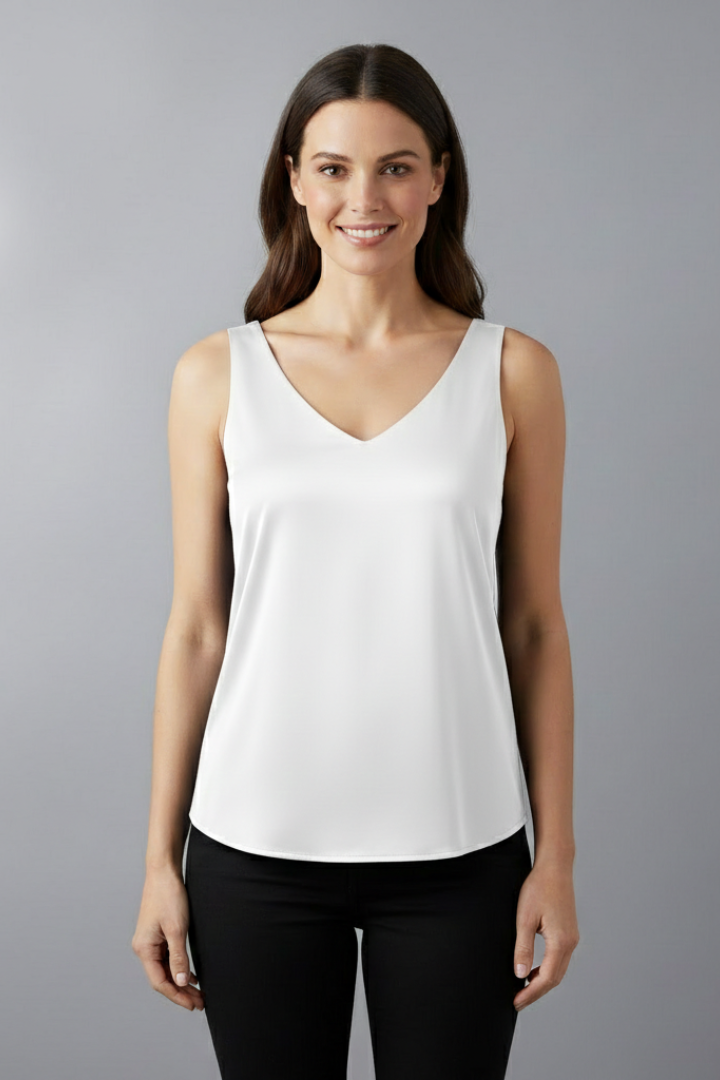 White dressy casual top against plain background