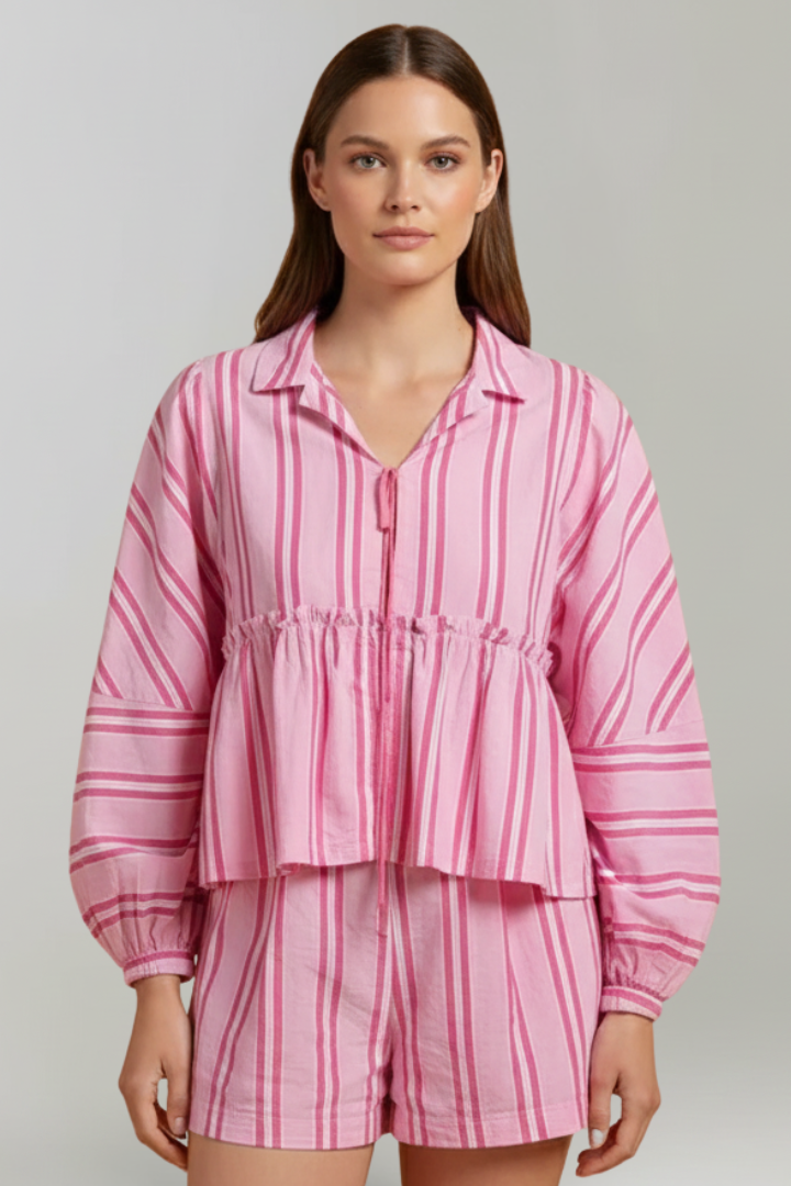 Female model front view striped outfit on plain gray background