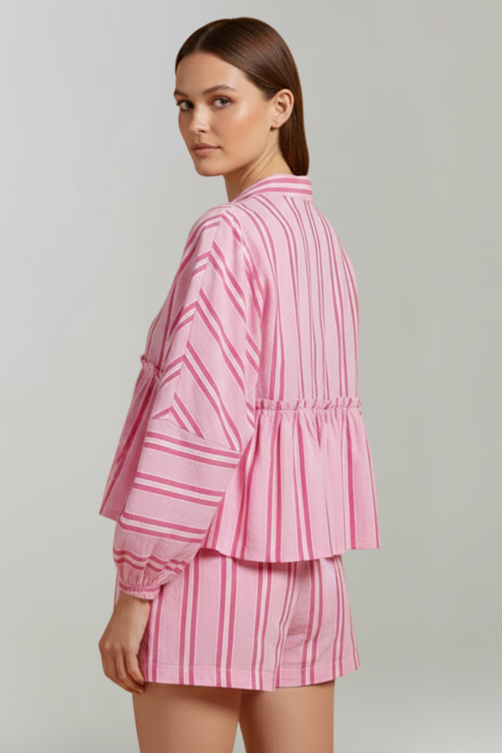 Woman pose in back view striped coordinated outfit pink set in gray background 